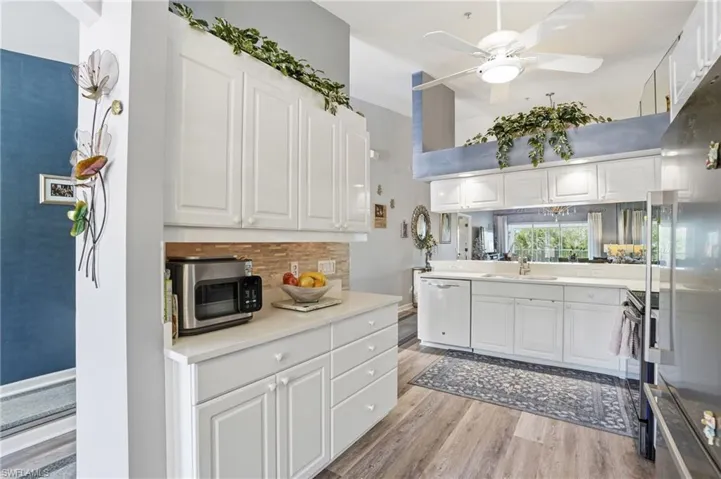 Kitchen featuring white cabinetry, ceiling fan, light countertops, and high end refrigerator