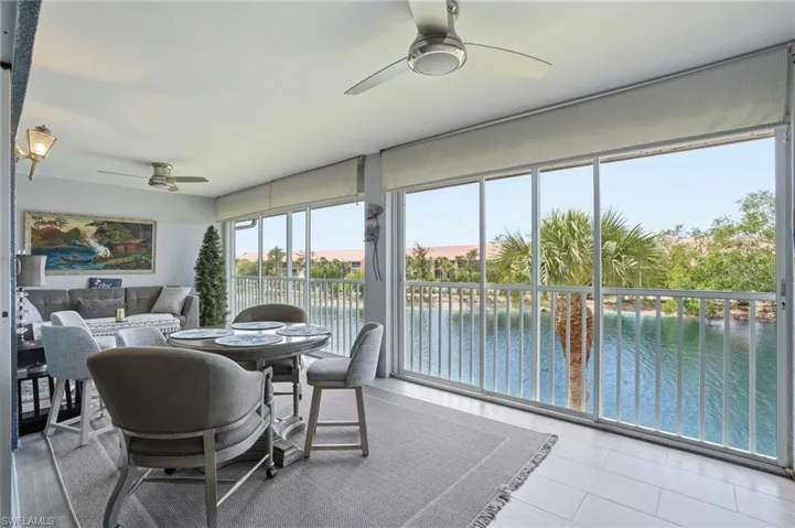 Sunroom featuring a water view