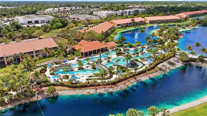 Bird's eye view of a nearby body of water and a pool