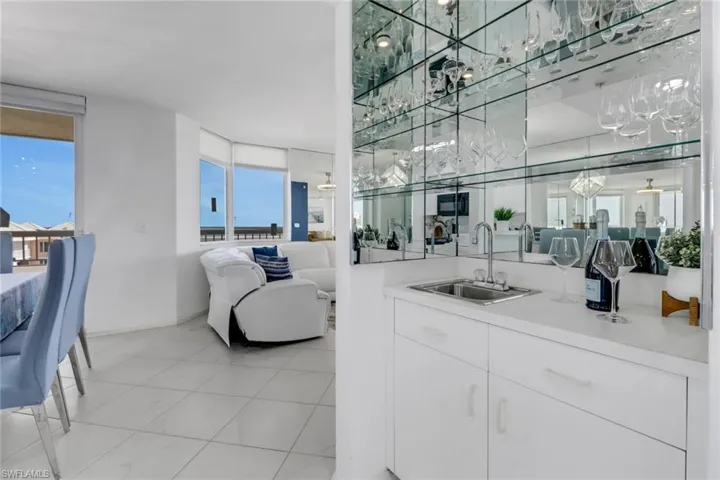Bar area with light countertops and white cabinetry