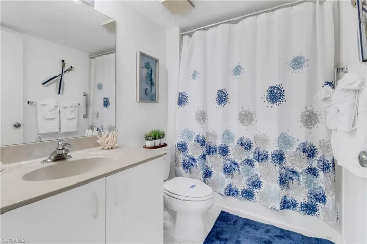 Full bathroom with vanity, tile patterned floors, and shower / tub combo with curtain