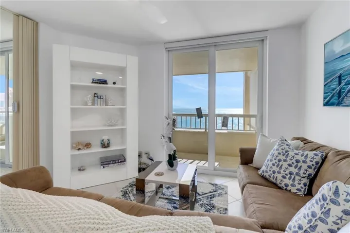Living area featuring light tile patterned flooring and a water view