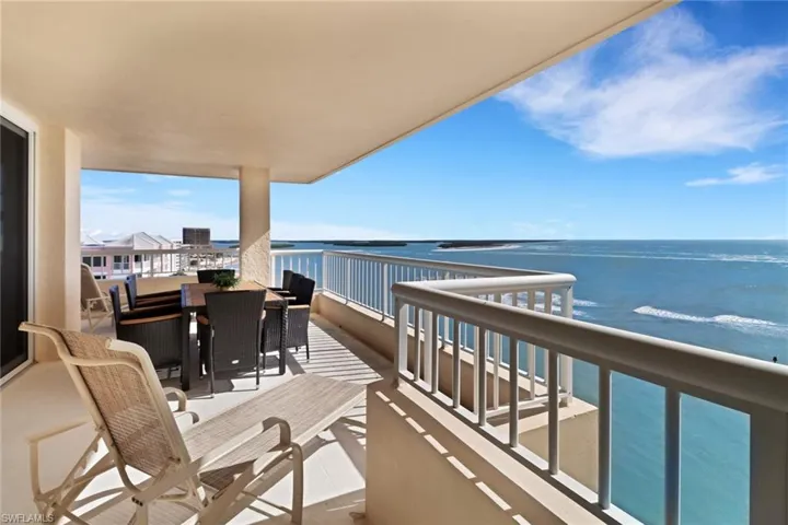 Balcony with a water view and outdoor dining space