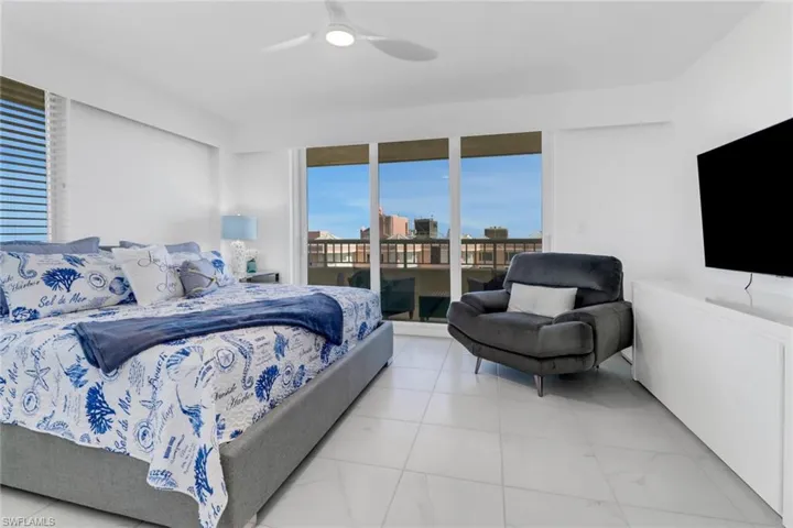Bedroom featuring a ceiling fan and access to outside