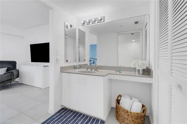 Bathroom with a closet and vanity