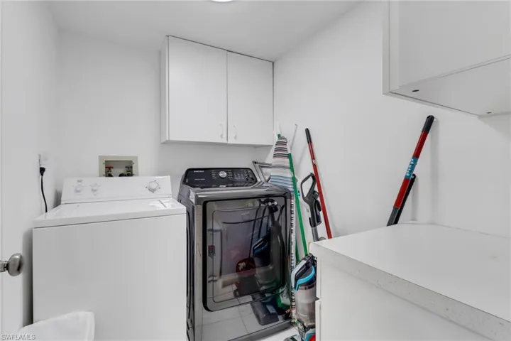 Laundry area featuring cabinet space and independent washer and dryer