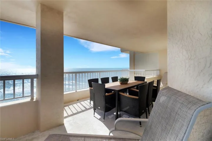 Balcony with a water view and outdoor dining area