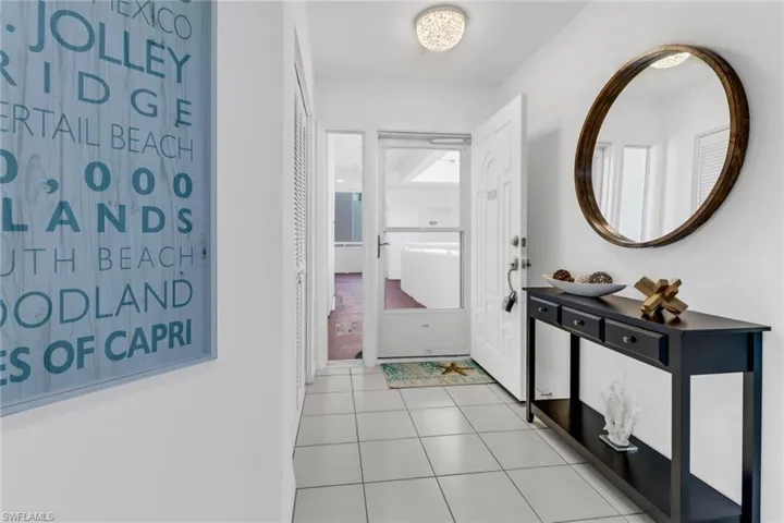 Hallway with light tile patterned floors