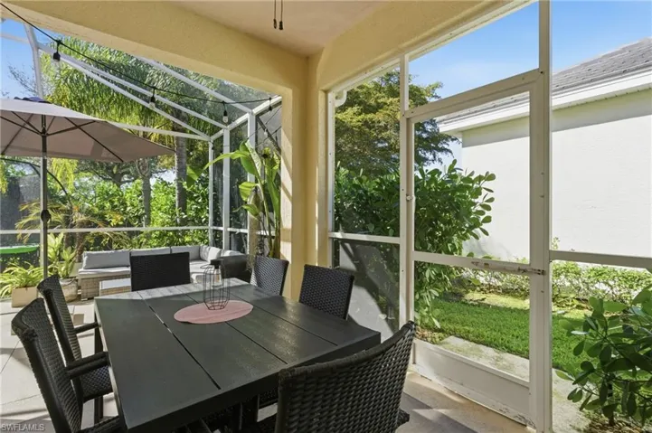 Sunroom / solarium featuring an outdoor living / dining area and a patio area