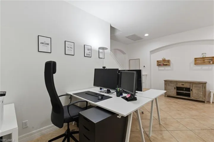 Home office featuring light tile patterned floors and recessed lighting