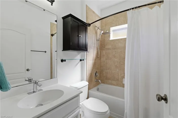Full bathroom featuring shower / tub combo and vanity