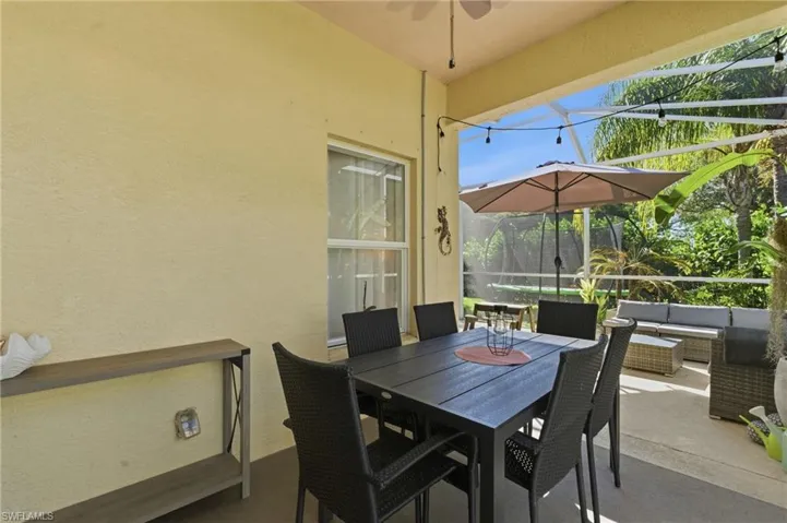 View of patio with a lanai, a sunroom, outdoor lounge area, and ceiling fan