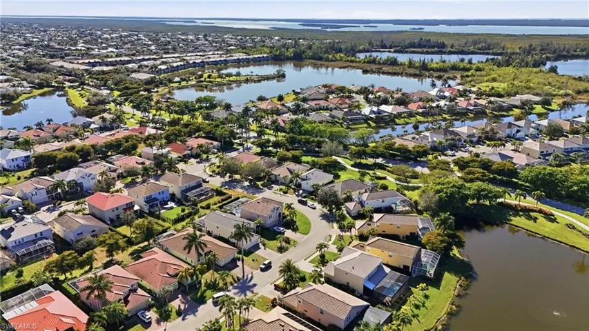 View of property location featuring a large body of water and nearby suburban area