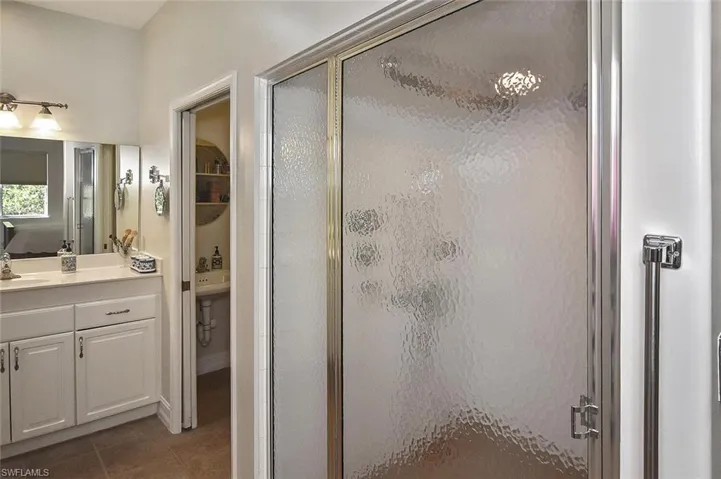 The Primary Ensuite' has walk-in shower, single sink vanity with plenty of storage and a private water closet with sink and pocket door