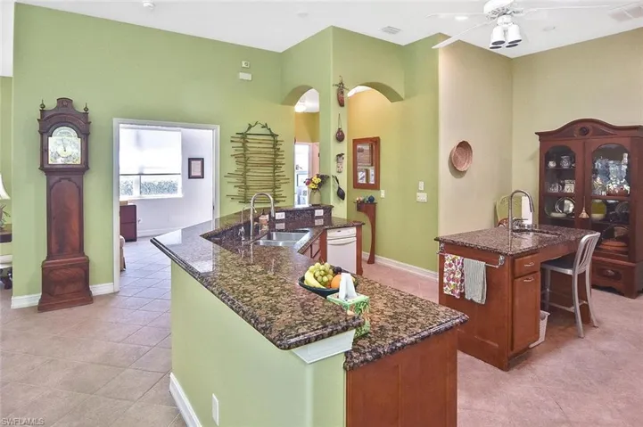 The Kitchen has granite counters stainless sinks and white appliances