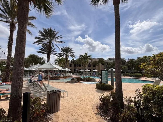View of pool featuring a patio area and a hot tub