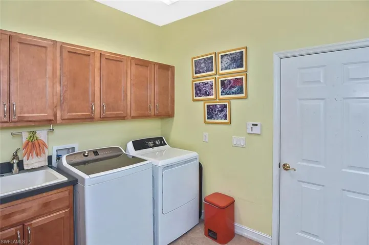 Laundry Room is unusually large with plenty of storage even for crafts.