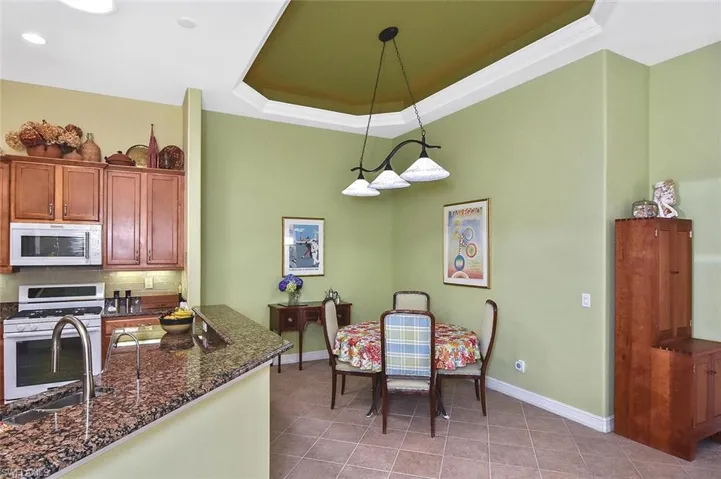 Dining area with lighted tray ceiling is gently nestled in the perfect spot adjacent to the Gathering Room.  A space that gives you the option to expand your dining table considerably when needed.