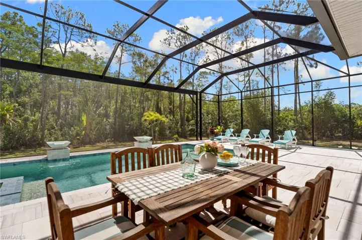 OVERSIZED Italian marble pool deck, outdoor shower, and a picture screen enclosure capturing unobstructed nature views