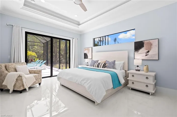 Primary suite offers direct lanai access & dual walk-in closets