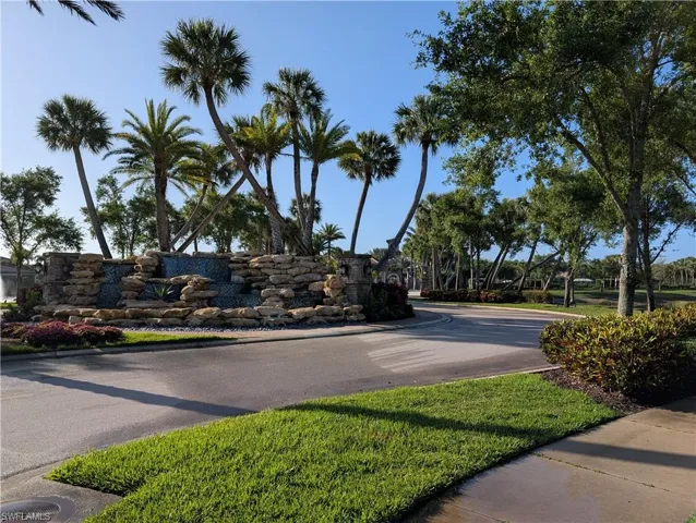View of asphalt road featuring curbs and sidewalks