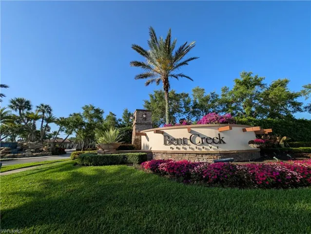Community / neighborhood sign featuring a yard