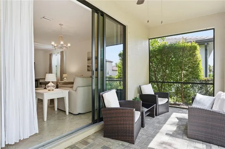 Sunroom featuring hanging lights and ceiling fan