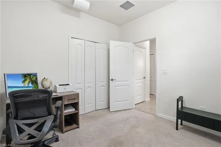 Office space featuring light colored carpet and baseboards