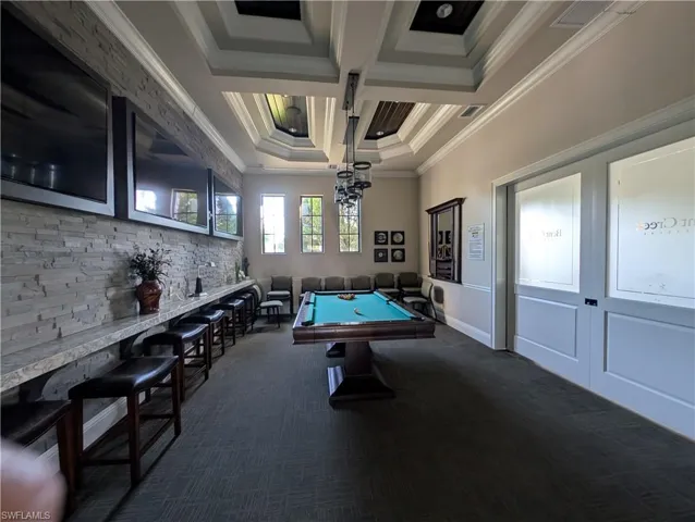 Game room featuring billiards table, coffered ceiling, and ornamental molding