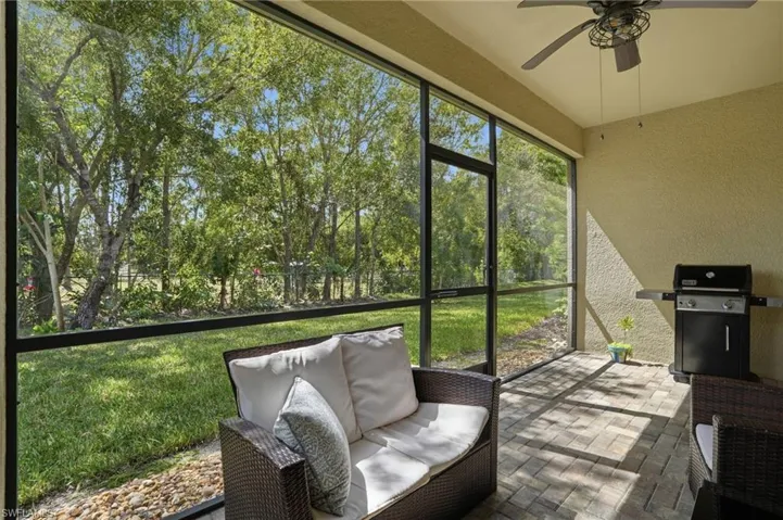 Sunroom / solarium with a ceiling fan and an outdoor living space