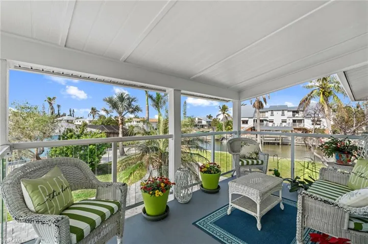 Sunroom / Porch solarium with a water view and plenty of natural light VIRTUALLY ENHANCED
