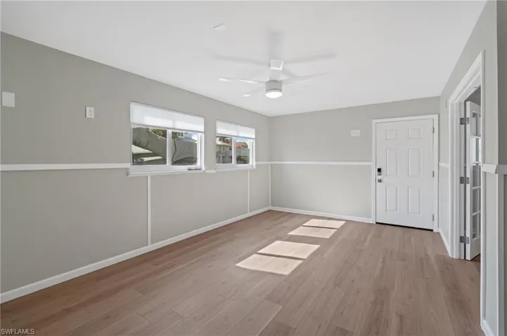 Spare room with ceiling fan and light hardwood / wood-style flooring /  virtually enhanced photo