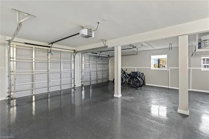 Garage featuring a  garage door opener /  virtually enhanced photo
