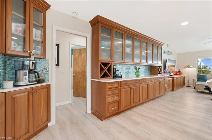 Kitchen featuring lofted ceiling, light hardwood / wood-style floors, and backsplash / virtually enhanced