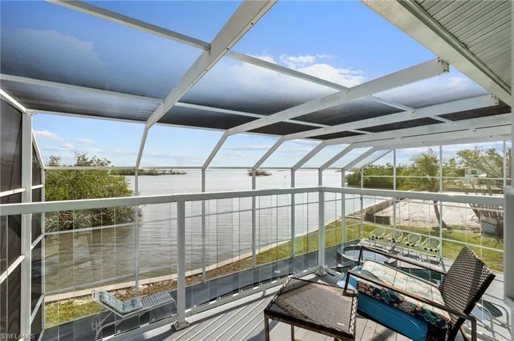 Unfurnished sunroom featuring a water view  VIRTUALLY ENHANCED