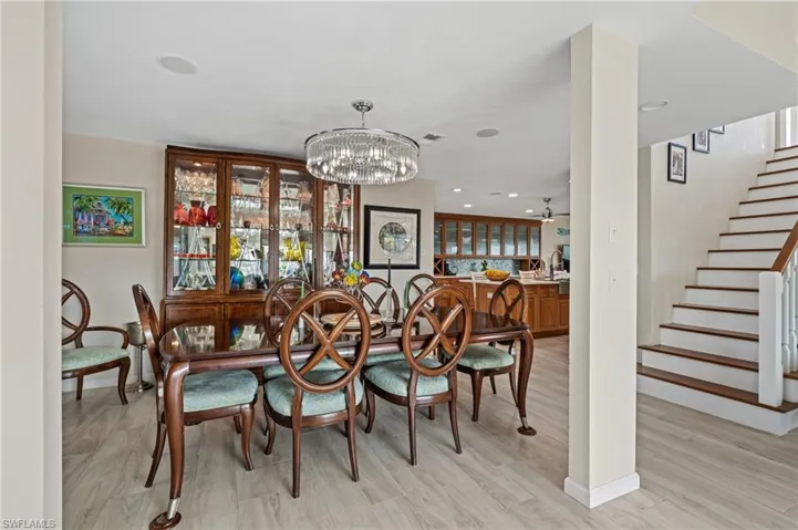 Dining room with a chandelier and light hardwood / wood-style flooring / virtually enhanced