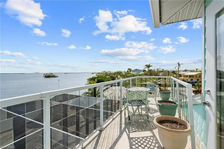 Balcony featuring a water view VIRTUALLY ENHANCED