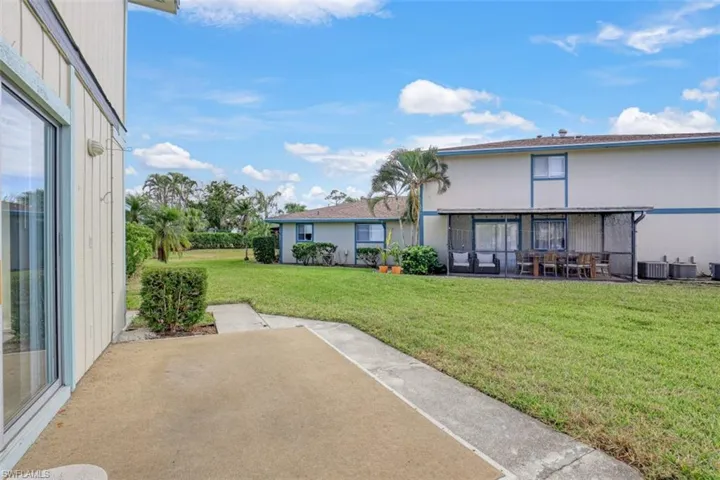 View of yard with central AC and a patio