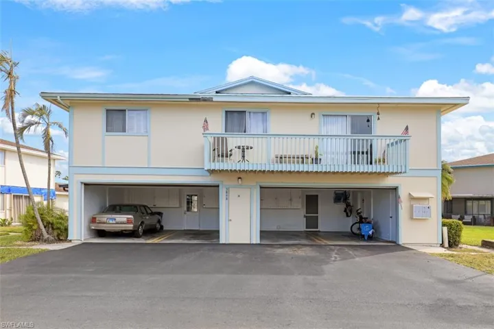 Multi unit property with a balcony and a garage