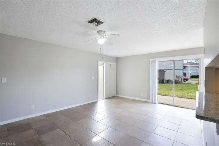 Empty room with ceiling fan and tile patterned floors