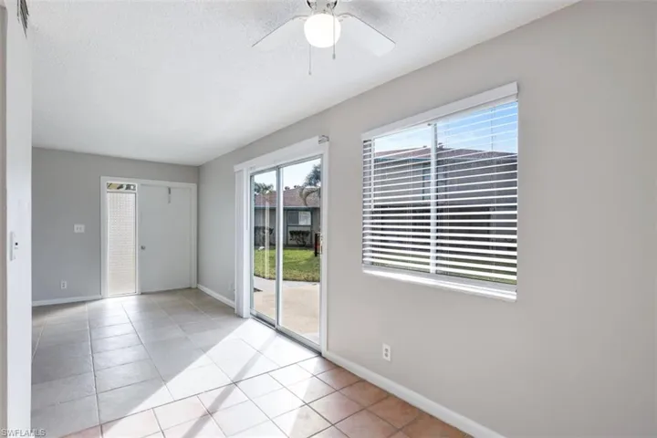 Unfurnished room featuring light tile patterned flooring and ceiling fan