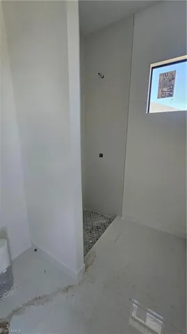 Full bath with walk in shower and baseboards
