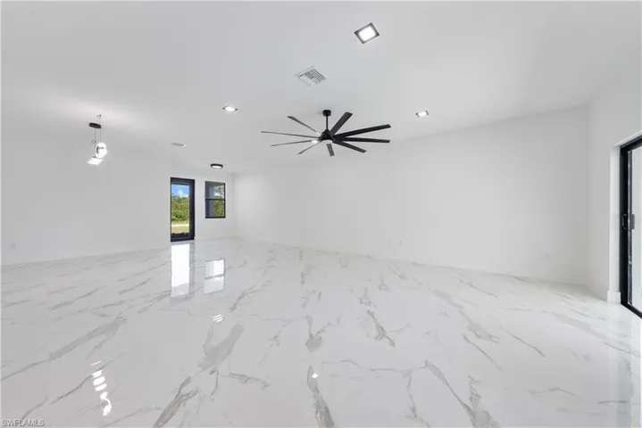 Unfurnished room with recessed lighting, visible vents, marble finish floor, and a ceiling fan