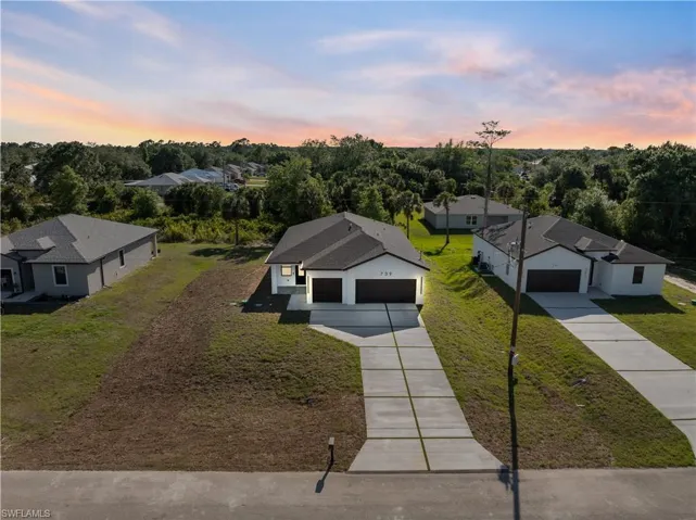 Aerial view at dusk featuring a residential view