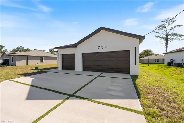 Garage with driveway and central AC