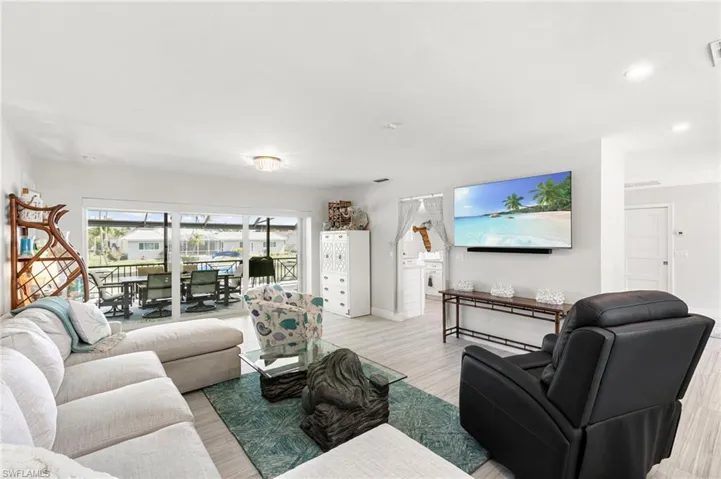 Living area featuring light wood-type flooring and recessed lighting