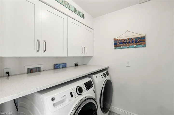 Laundry area with independent washer and dryer and cabinet space
