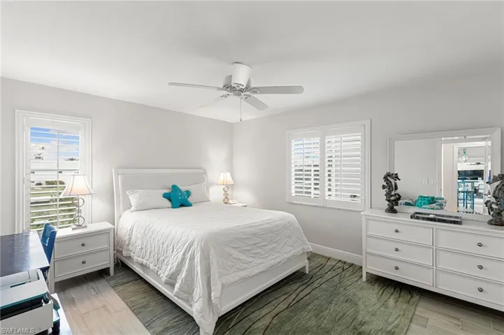Bedroom with light wood-type flooring and a ceiling fan