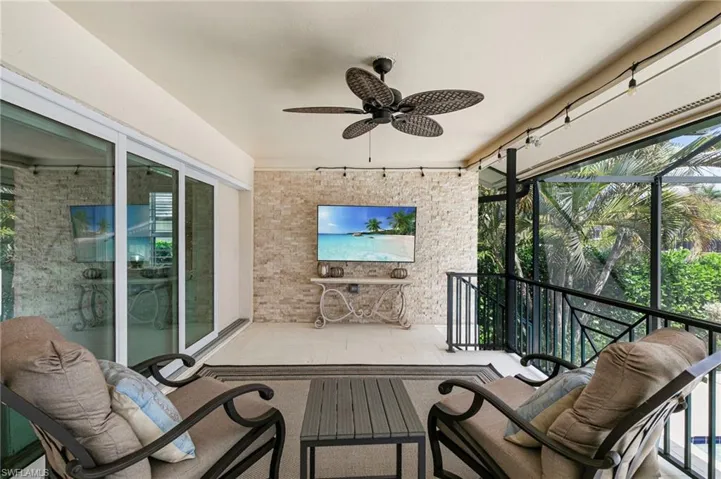 Sunroom / solarium with ceiling fan and healthy amount of natural light