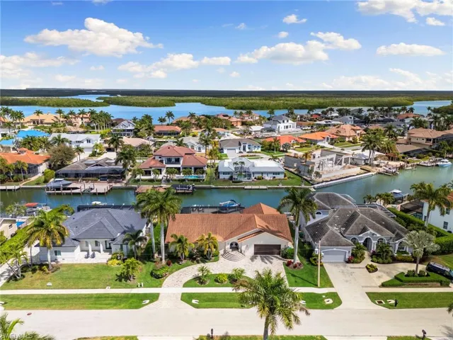 Aerial perspective of suburban area featuring a nearby body of water